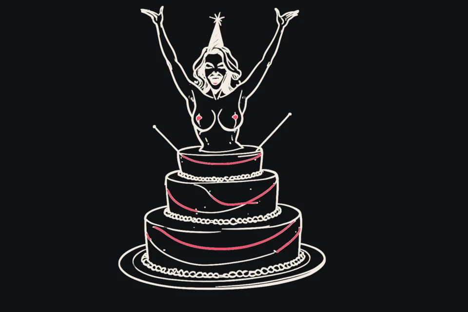 A woman bursts out of a giant birthday cake with her arms up