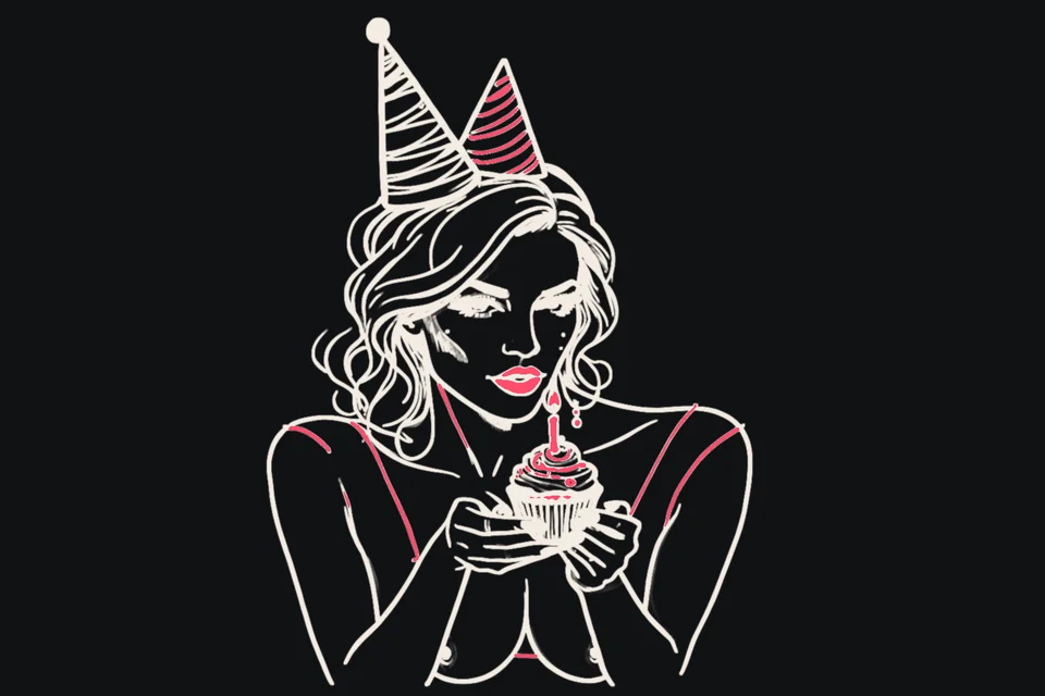 A woman in a party hat holds a cupcake with a candle