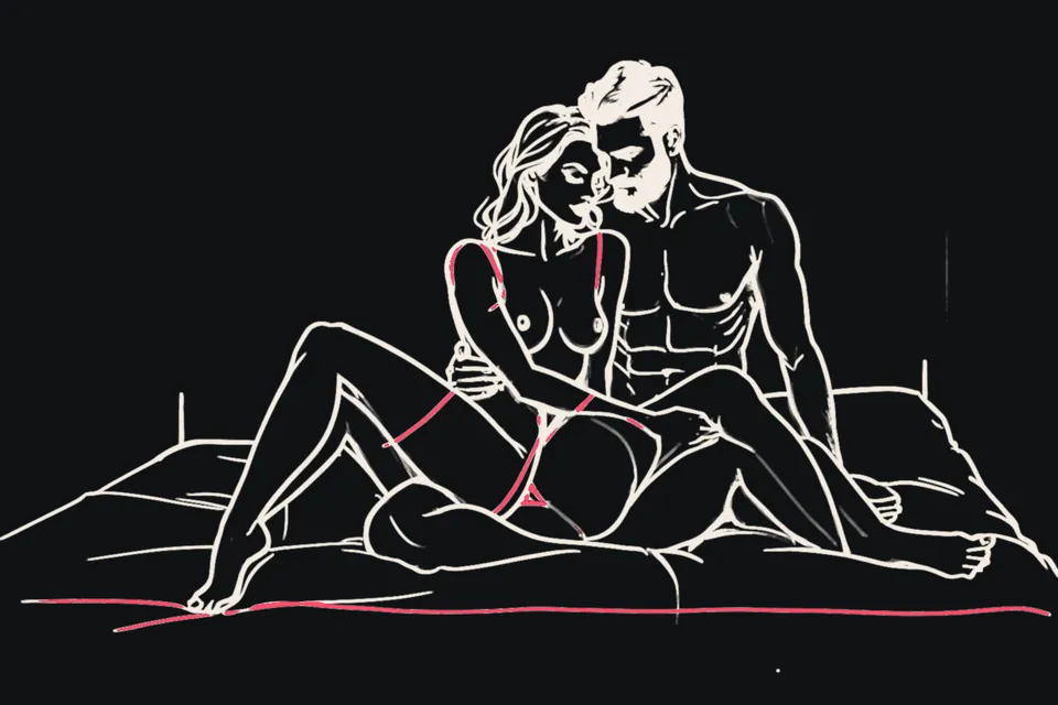 A couple sits together on a bed