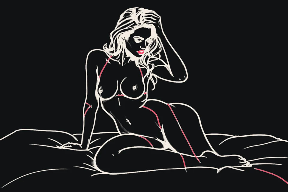 A woman kneels on a bed with a hand in her hair