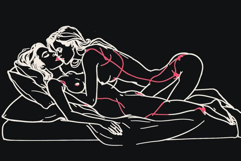 Two women kiss in bed