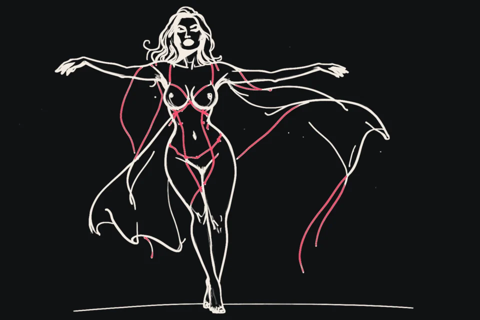 A woman stands with open arms, her dress at her feet