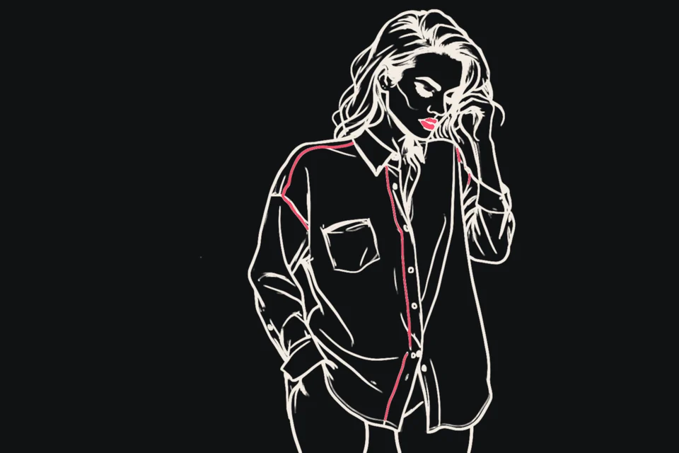 A blushing woman peeks over the collar of an oversized shirt