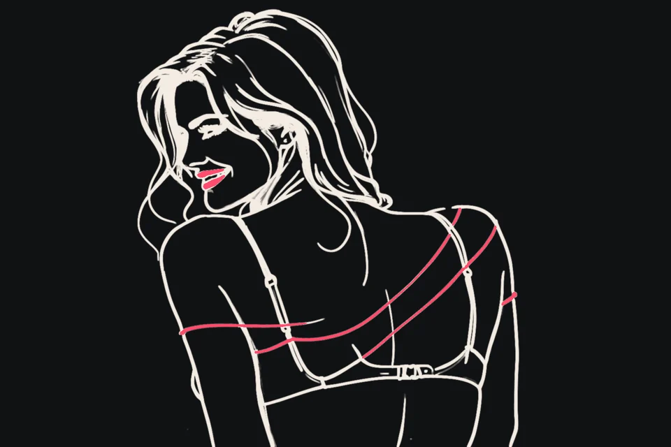 A woman slides a strap off her shoulder and glances back