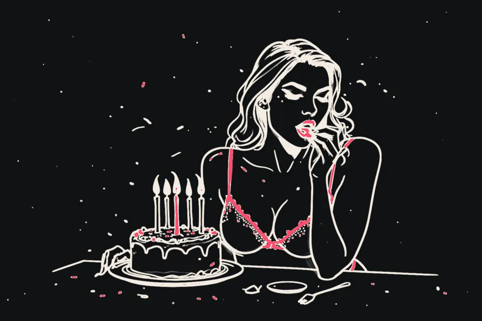 A woman in party lingerie blows out the candles on a birthday cake